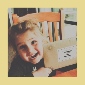 Happy child excited to receive a traditional letter via traditional post