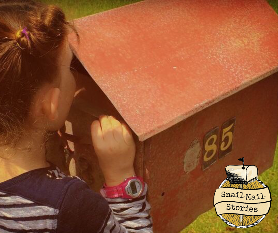snail mail for kids - child peeking into a traditional post box